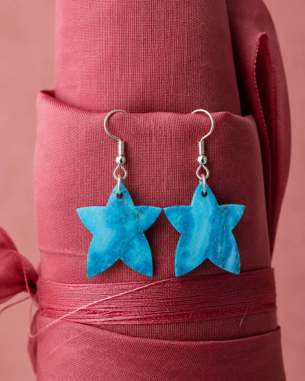 Handcrafted Noor Stella turquoise stone earrings displayed on a premium linen background by Pietra Noor.
